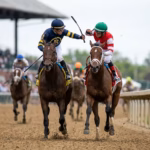 Two jockeys fighting each other with their whips.