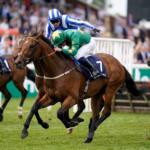 Two jockeys riding while one jockey is chastising the other