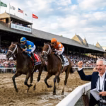 Todd Pletcher cheering two horses racing at the Belmont Stakes at Saratoga