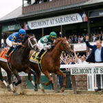 Todd Pletcher cheering two horses racing at the Belmont Stakes at Saratoga